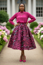 African model wearing pink and black patterned midi skirt with matching blouse